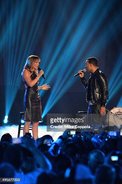 Jennifer Nettles and John Legend perform onstage during the 2014 CMT Music awards at the Bridgestone Arena on June 4, 2014 in Nashville, Tennessee.
