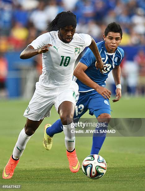 Ivory Coast's forward Gervinho dodges El Salvador's midfielder Alexander Larin during a World Cup preparation match between Ivory Coast and El...