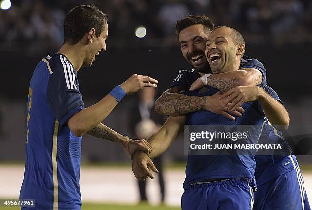 Argentina's midfielder Javier Mascherano celebrates with teammates forward Ezequiel Lavezzi and midfielder Angel Di Maria after scoring the team's...