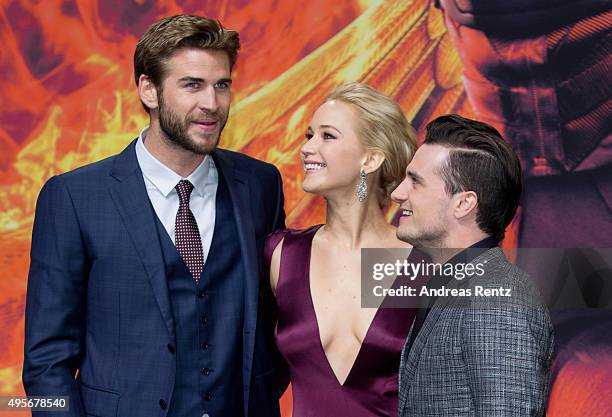 Liam Hemsworth, Jennifer Lawrence, wearing a Dior dress and Josh Hutcherson attend the world premiere of the film 'The Hunger Games: Mockingjay -...