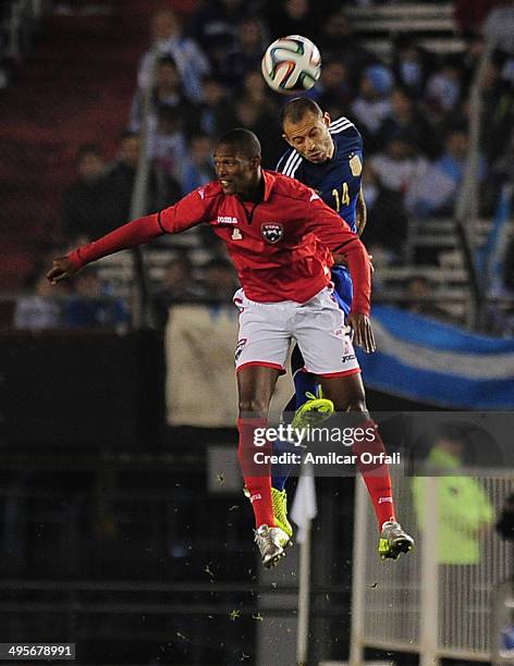 Javier Mascherano of Argentina struggles for the ball with Atahulla Guerra during a FIFA friendly match between Argentina and Trinidad & Tobago at...