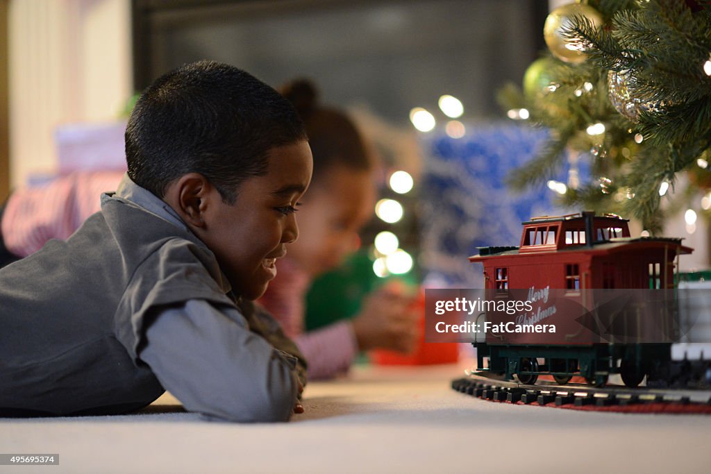 Children Playing with a Toy Train