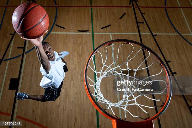 man dunking a baskteball - basketball dunk stock pictures, royalty-free photos & images