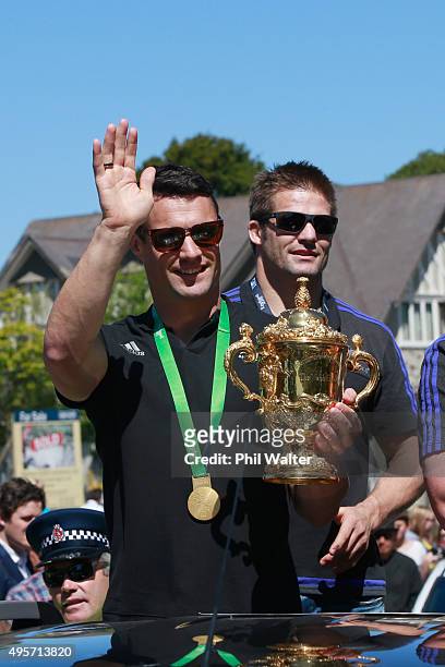 Dan Carter and Richie McCaw of the All Blacks with the Webb Ellis Cup as they drive towards Hagley Park during the New Zealand All Blacks welcome...