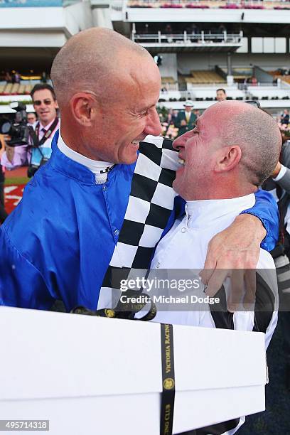 Jockey Jim Cassidy, retiring after racing today, is hugged by jockey Glen Boss on Oaks Day at Flemington Racecourse on November 5, 2015 in Melbourne,...