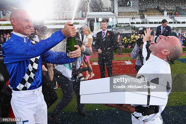 Jockey Jim Cassidy, retiring after racing today, is kissed showered with champagne by Glen Boss on Oaks Day at Flemington Racecourse on November 5,...