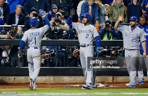Jarrod Dyson of the Kansas City Royals celebrates with teammate Alcides Escobar after scoring a run in the 12th inning against the New York Mets...