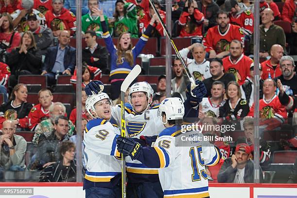 David Backes of the St. Louis Blues celebrates with Scottie Upshall and Robby Fabbri after scoring and tying the game in the second period of the NHL...