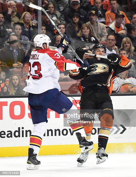 Jakob Silfverberg of the Anaheim Ducks is stood up with a check from Willie Mitchell of the Florida Panthers during the first period at Honda Center...