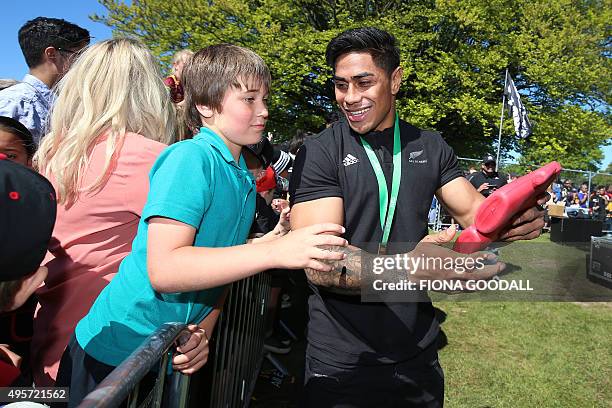 New Zealand's All Blacks rugby team player Malakai Fekitoa chats with fans at an official welcome parade and reception for the team in Christchurch...