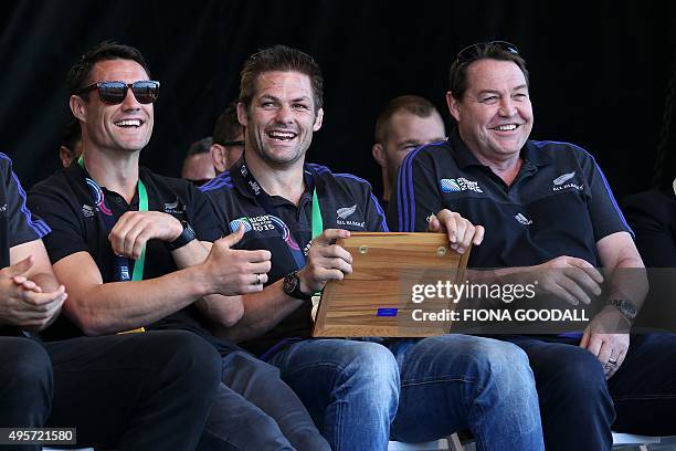 New Zealand's All Blacks rugby team players Dan Carter captain Richie McCaw and coach Steve Hansen attend an official welcome parade and reception...