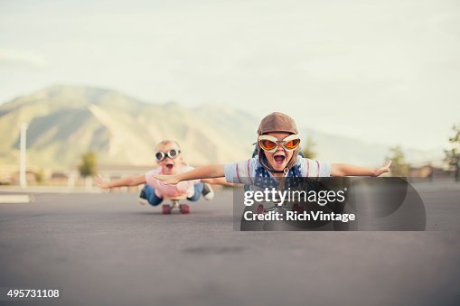 Young Boy and Girl Imagine Flying On Skateboard Young Boy and Girl Imagine Flying On Skateboard