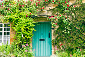 Charming House with green doors and red roses