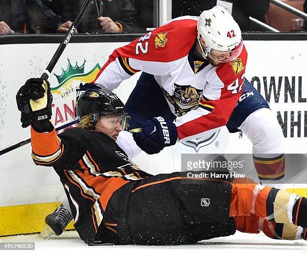 Hampus Lindholm of the Anaheim Ducks is knocked to the ice by Quinton Howden of the Florida Panthers during the second period at Honda Center on...
