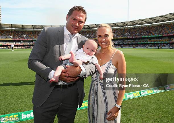 Former Test Bowler Ryan Harris of Australia is given a lap of honour with wife Cherie and their son Carter during day one of the First Test match...