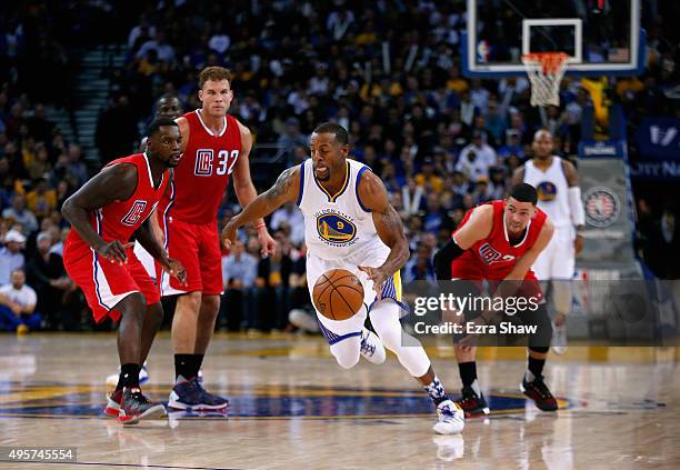 Andre Iguodala of the Golden State Warriors dribbles past Lance Stephenson, Blake Griffin and Austin Rivers of the Los Angeles Clippers at ORACLE...