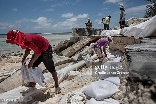 Damaged roads due to the flooding in Kirbati - Tarawa's single paved road has collapsed because of the flooding from the sea. The people of Kiribati...