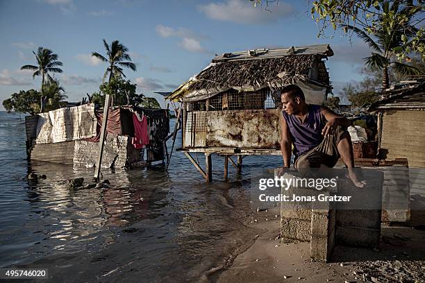 One of the residents of the village Eita is sitting and watching the ocean water slowly flood his village. The people of Kiribati are under pressure...