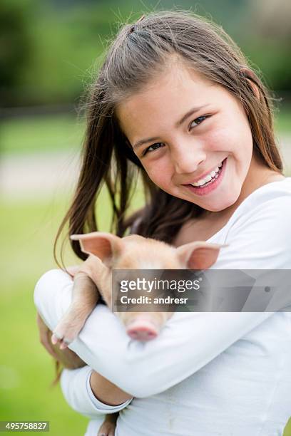 girl holding a pig - keutje stockfoto's en -beelden