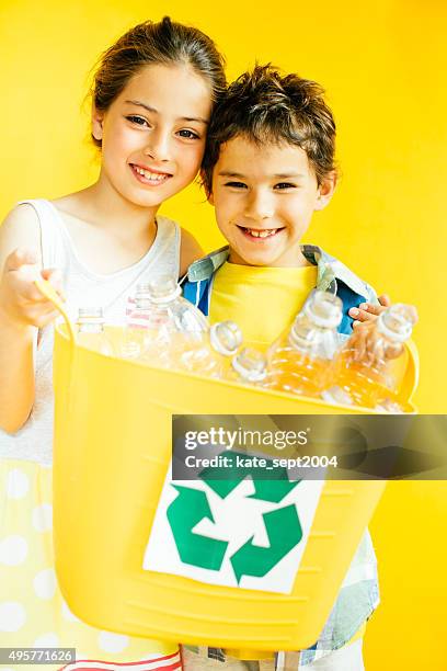 smiling kids with recycling bin - 2004 2015 stock pictures, royalty-free photos & images