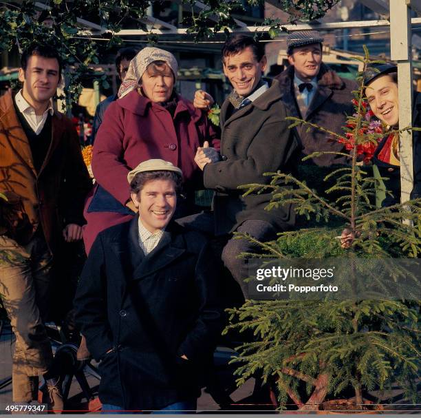 View of the cast of the television soap opera 'Market In Honey Lane' including the actors Pat Nye, John Bennett and Brian Rawlinson with Christmas...