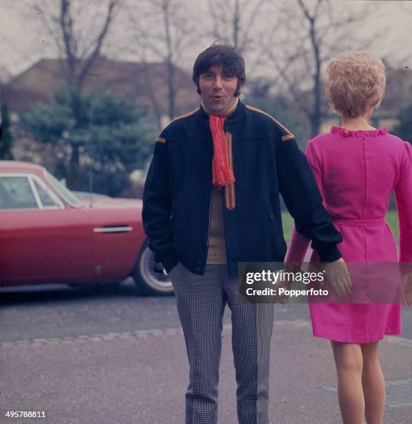 English comedian Jimmy Tarbuck pictured patting a young girl on the bottom in 1968.