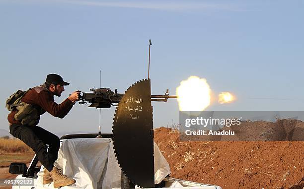 Member of Syrian opposition group linked to Damascus Front fires a heavy-machine gun during clashes with Daesh militants in the Tel Malid village...