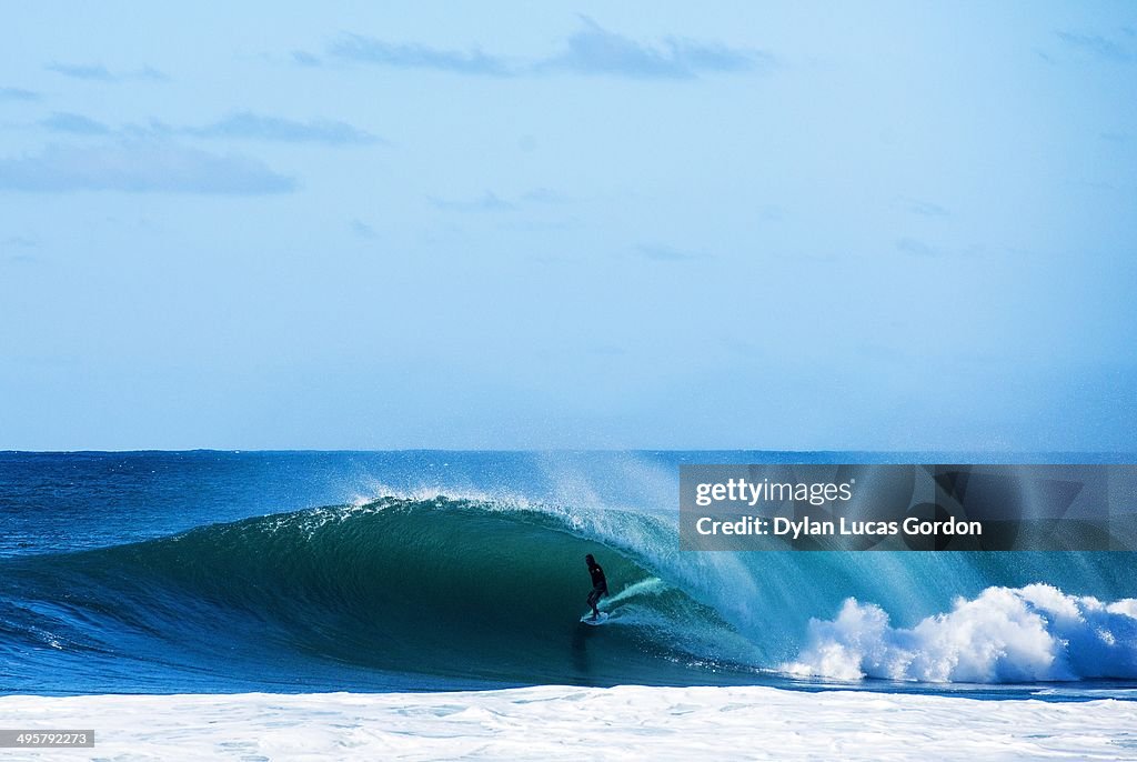 Surfer comes out of backdoor wave