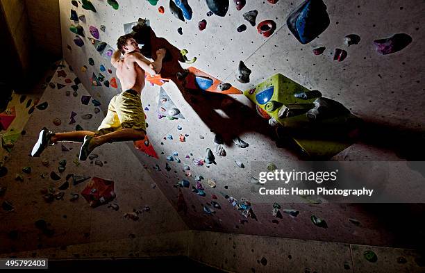 man bouldering at indoor climbing centre - bouldering - fotografias e filmes do acervo