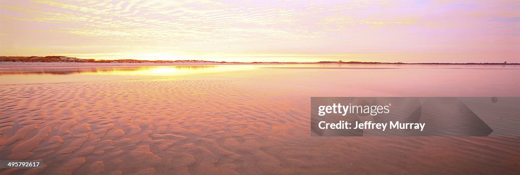 A stretch along the sandy beach of Cape Henlopen State Park, Delaware taken at sunrise.