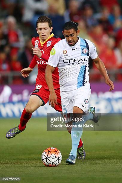 David Williams of Melbourne City competes with Craig Goodwin of Adelaide United during the round five A-League match between Adelaide United and...