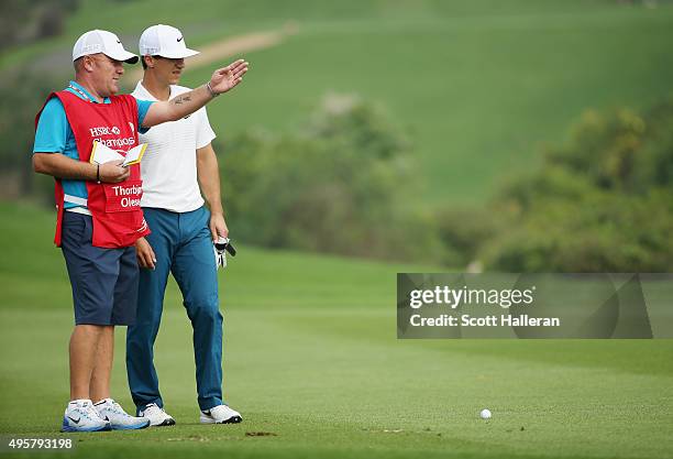 Thorbjorn Olesen of Denmark chats with his caddie Dominic Bott on the second hole during the first round of the WGC - HSBC Champions at theSheshan...