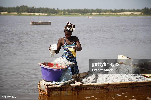 An African woman is seen during the process of taking salt out of the Lake Retba, 40 kilometers away from Dakar in Senegal, on November 5, 2015. Lake...