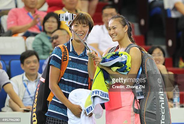 Shilin Xu of China and Xiaodi You of China take a selfie after winning the doubles match against Gabriela Dabrowski of Canada and Alicja Rosolska of...