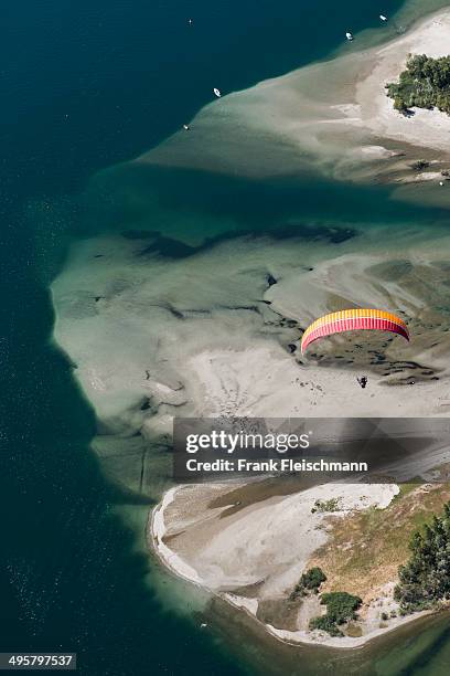 paraglider over the maggia river delta with naturally formed water and rocks terrain, locarno, kanton tessin, switzerland - kanton tessin stock pictures, royalty-free photos & images