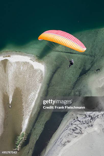 paraglider over the maggia river delta with naturally formed water and rocks terrain, locarno, kanton tessin, switzerland - kanton tessin stock pictures, royalty-free photos & images