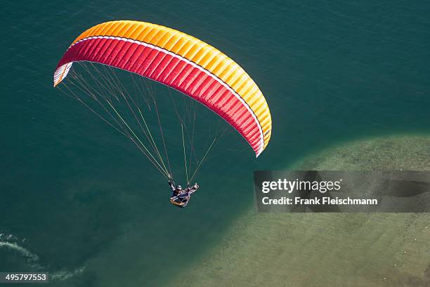 paraglider over the maggia river delta with naturally formed water and rocks terrain, locarno, kanton tessin, switzerland - kanton tessin stock pictures, royalty-free photos & images