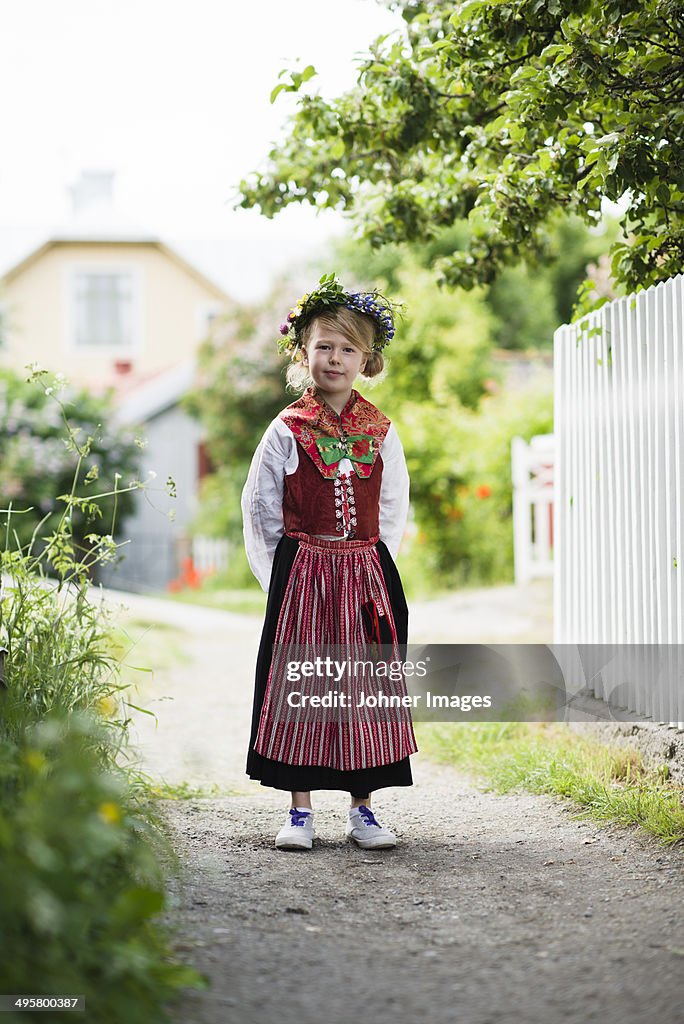 Girl in national costume wearing flower wreath, Sandham, Sweden