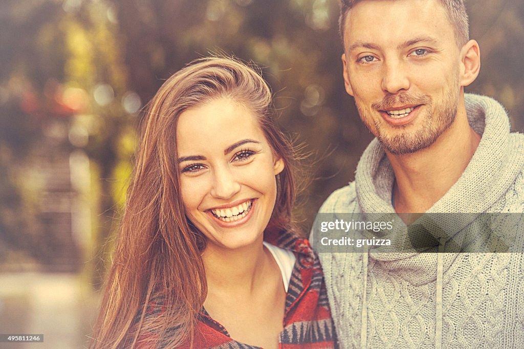 Young loving couple holding hands in stroll through the nature