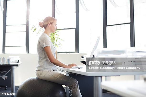 de-stress at your desk - fitness ball stock pictures, royalty-free photos & images