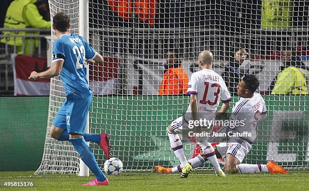 Artem Dzyuba of FC Zenit scores his second goal despite Christophe Jallet and Corentin Tolisso of Lyon during the UEFA Champions league match between...
