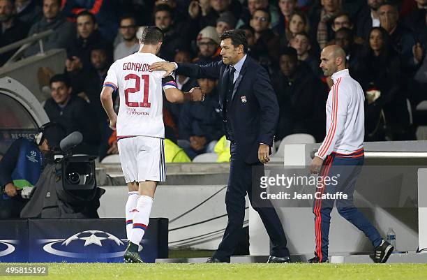 Coach of Lyon Hubert Fournier greets Maxime Gonalons of Lyon while leaving the pitch after receiving a red card during the UEFA Champions league...