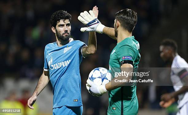 Luis Neto of FC Zenit and goalkeeper of FC Zenit Yuri Lodygin celebrate the victory after the UEFA Champions league match between Olympique Lyonnais...