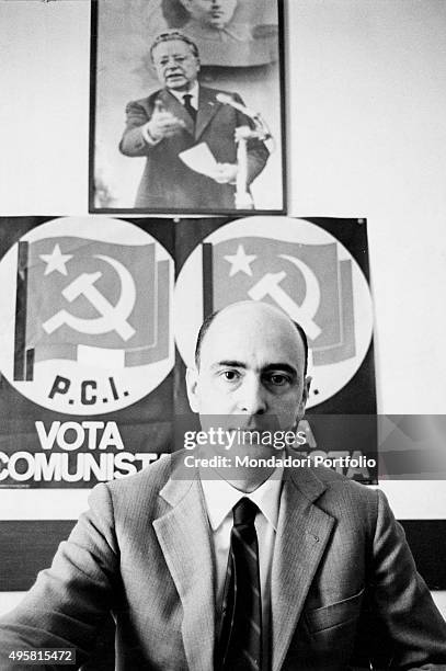 The Italian politician Giorgio Napolitano posing. Behind him, there are two posters of the Italian Communist Party and a photograph of Palmiro...