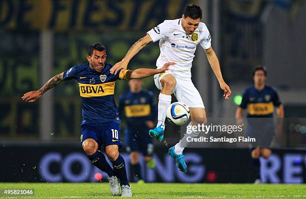 Carlos Tevez of Boca Juniors battles for the ball during a final match between Boca Juniors and Rosario Central as part of Copa Argentina 2015 at...