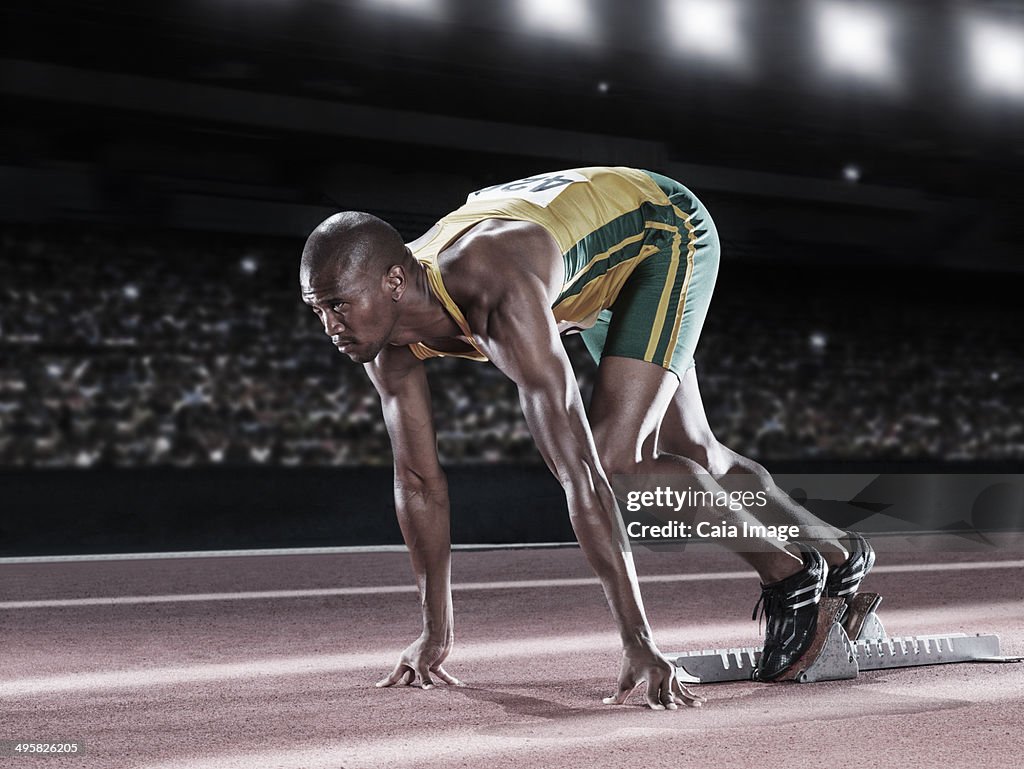 Runner poised at starting line on track