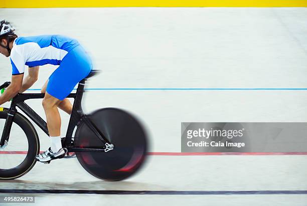 track cyclist riding in velodrome - cycling track stock pictures, royalty-free photos & images