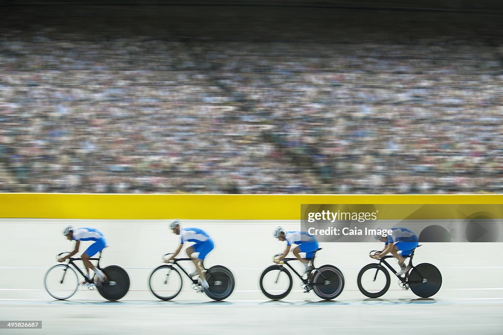 Track cycling team riding in velodrome