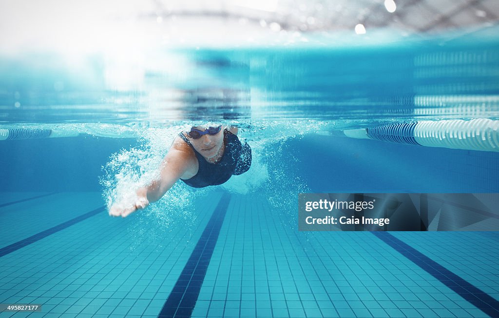 Swimmer racing in pool