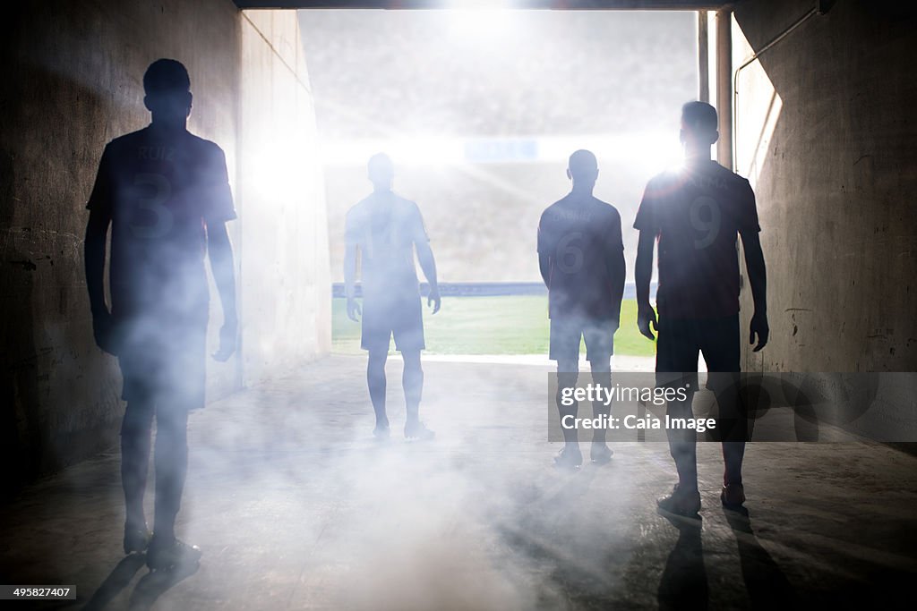 Silhouette of soccer teams facing field